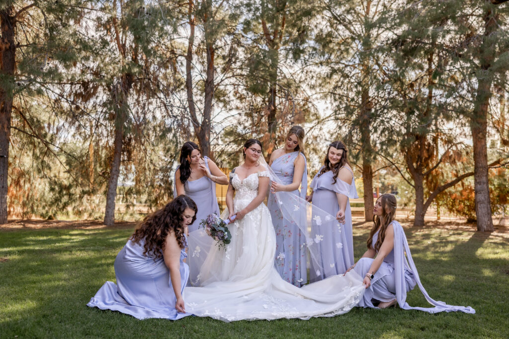 Bride with bridesmaids during wedding portraits at Schnepf Farms in Queen Creek, Arizona