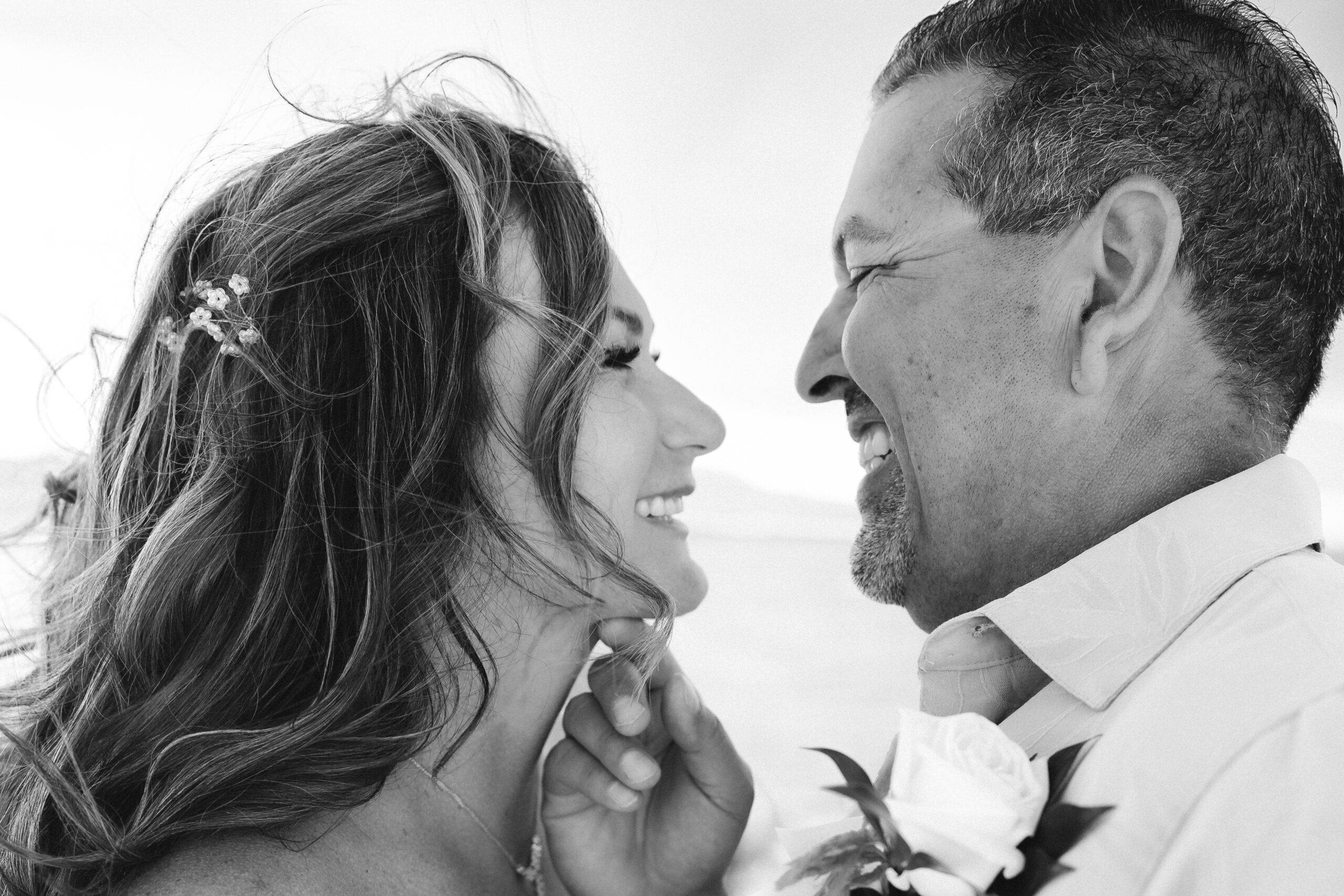 Intimate black and white wedding portrait of couple smiling at each other during Lake Havasu vow renewal