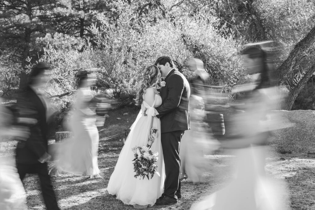 Bride and groom kiss wedding party motion blur Hualapai Mountain Resort Arizona
