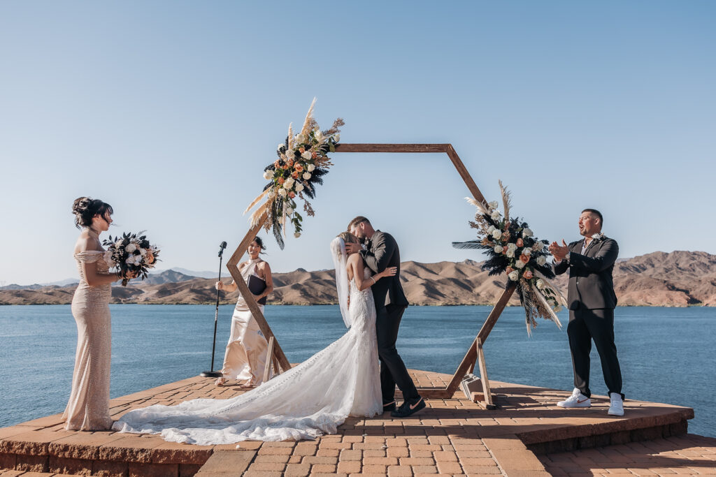 Madison and Caleb sharing their first kiss during their Havasu Springs wedding ceremony overlooking Lake Havasu