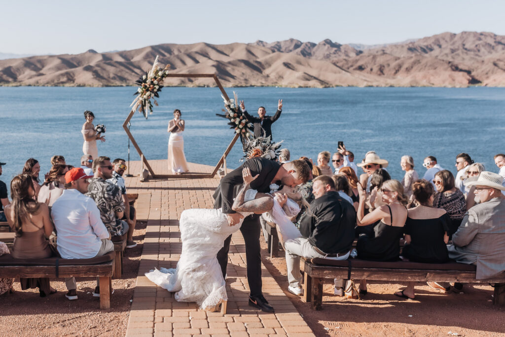Madison and Caleb sharing a romantic dipped kiss after their wedding ceremony at Havasu Springs