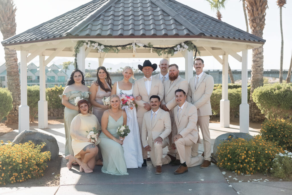 Katie, Darren, and their wedding party pose at the London Bridge Resort gazebo.