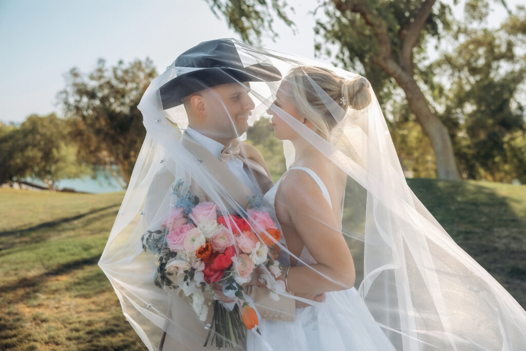 Darren kisses Katie’s forehead during a close wedding portrait.