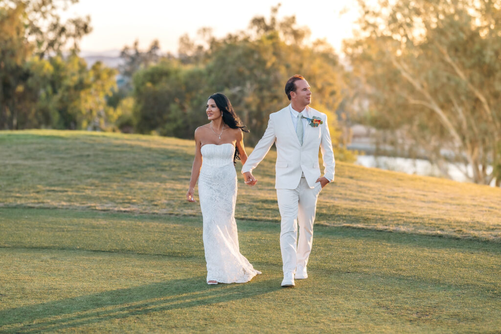 Paul and Lizzy walking hand in hand during their Lake Havasu wedding portraits