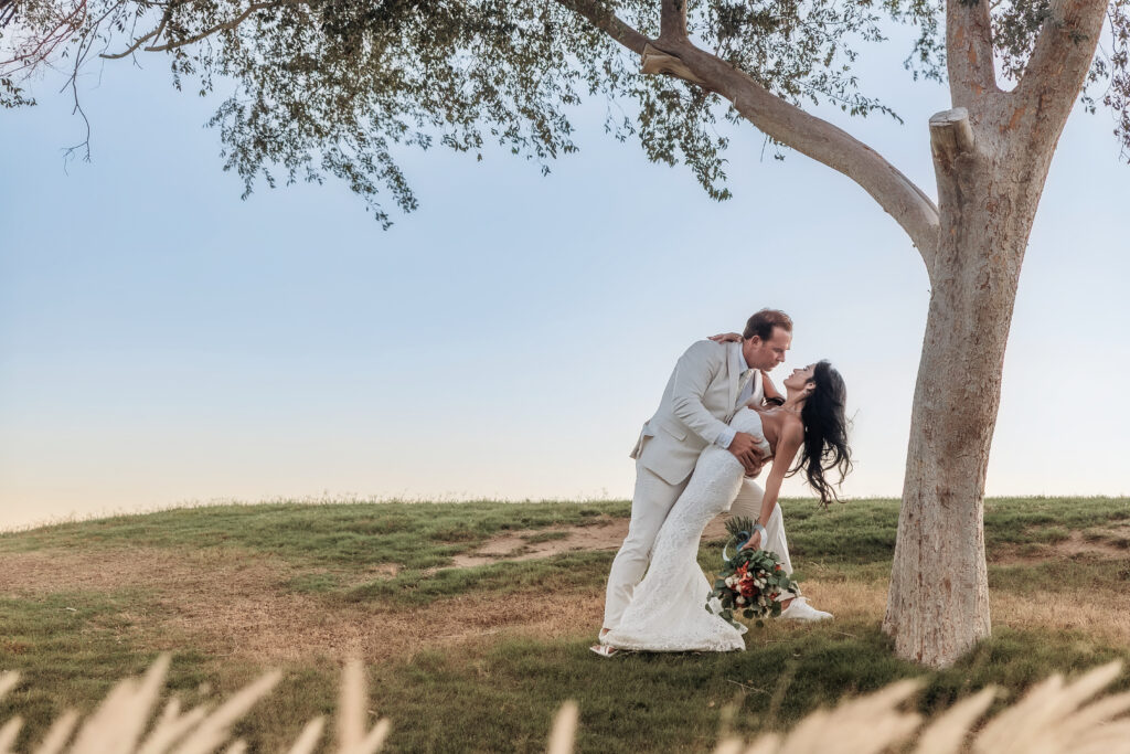 Paul and Lizzy during sunset portraits at their Lake Havasu wedding with Arizona mountains in the background