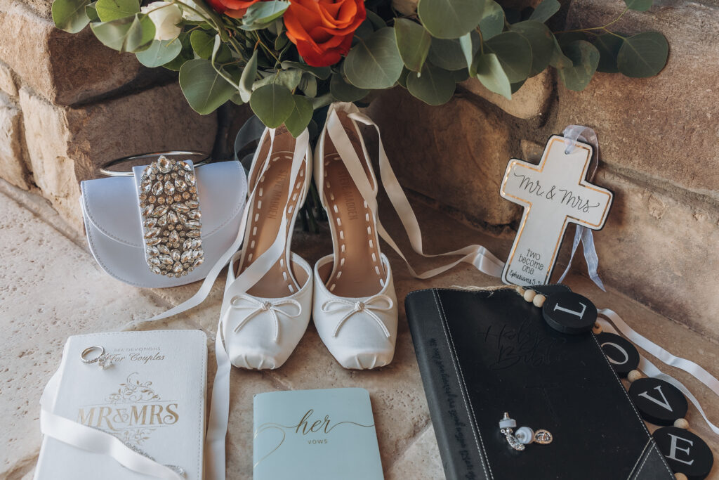 Lizzy’s bridal details with wedding shoes, bouquet, jewelry, ring box and cross at The Refuge