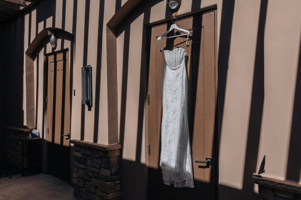 Lizzy’s wedding dress hanging outside the bridal suite at The Refuge before her Lake Havasu wedding